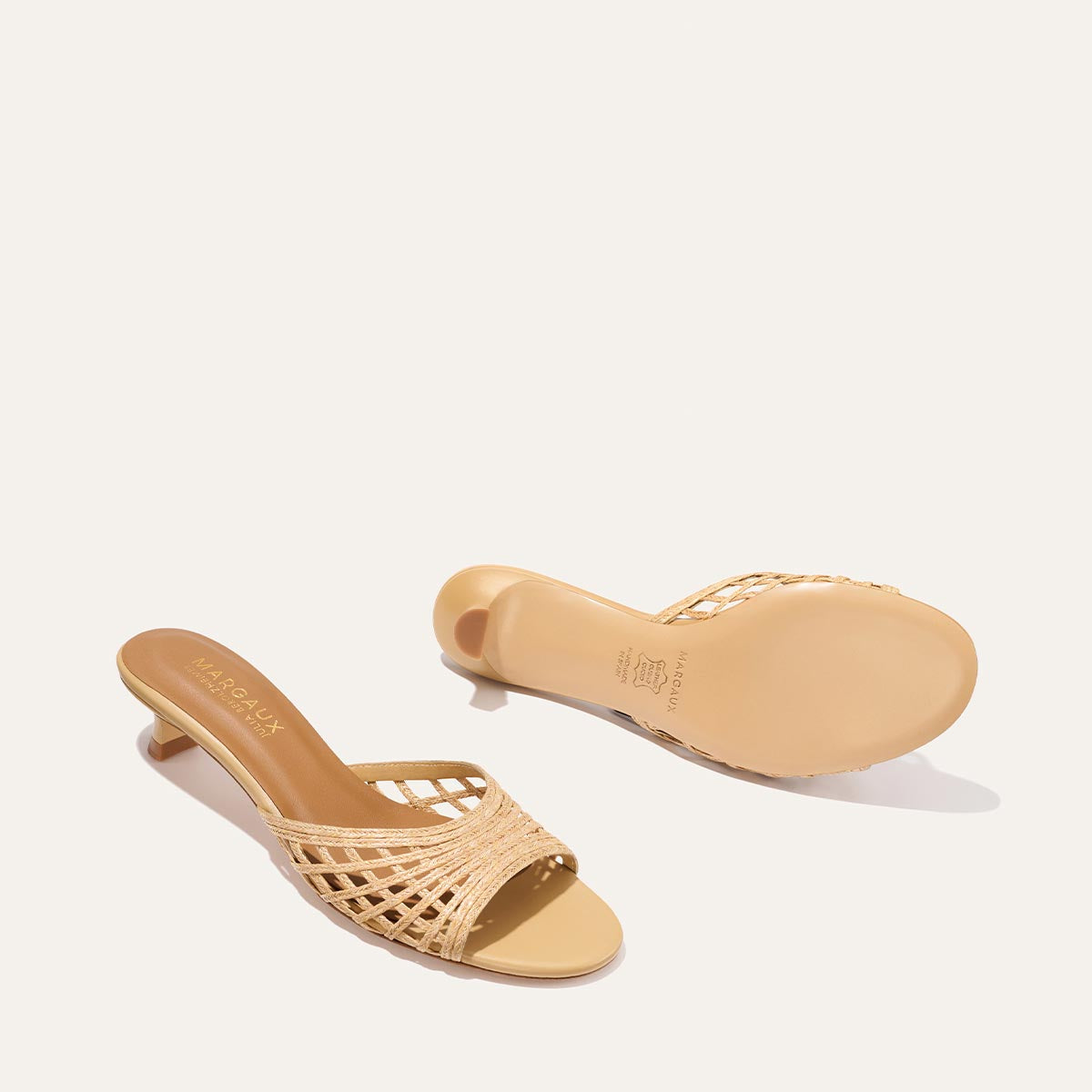 Pair of beige woven sandals on a light background