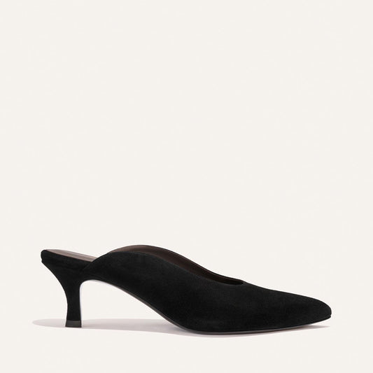 The Alison Roman x Margaux: The Parlor Mule in Black Suede by Margaux features a closed toe, low-cut sides, and a slender high heel, shown against a plain light background.