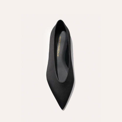 A top-down view of The Parra - Black Satin pointed-toe flat by margaux-development, set against a plain white background.