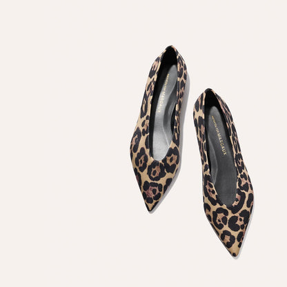 The Parra - Leopard Satin flats by margaux-development, featuring a pointed-toe and leopard print, displayed on a light beige background.