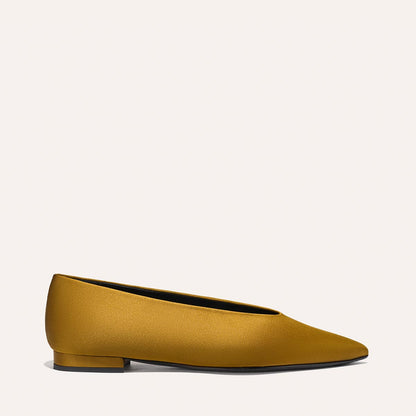 The Parra - Ochre Satin by margaux-development: a single mustard yellow flat shoe with a low heel, pointed toe, and smooth satin texture, displayed on a plain light background.