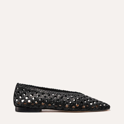 The Woven Paz by Margaux in black leather is a luxuriously soft flat with a pointed toe, low heel, and elegant perforated handwoven basket design, shown in profile against a plain light background.