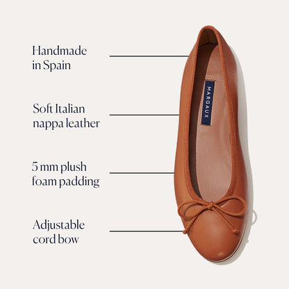 The Demi - Saddle Nappa by margaux-development is a bestselling ballet flat, handmade in Spain from soft Italian nappa leather, featuring 5 mm plush foam padding and an adjustable cord bow for exceptional comfort.