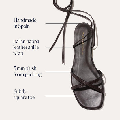The Wrap Sandal - Espresso Nappa by Margaux features crisscross straps, a subtly square toe, and a thin leather ankle wrap. Handmade in Spain from Italian nappa leather with 5 mm foam padding for versatile summer style.