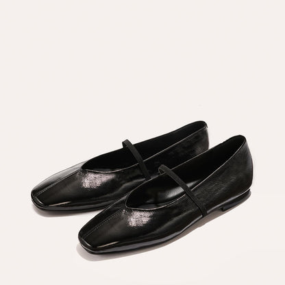 The Phoebe - Black Crinkle-Gloss Nappa by margaux-development: black, shiny square-toe ballet flats with thin straps and sacchetto construction for extra softness, shown on a plain light background.