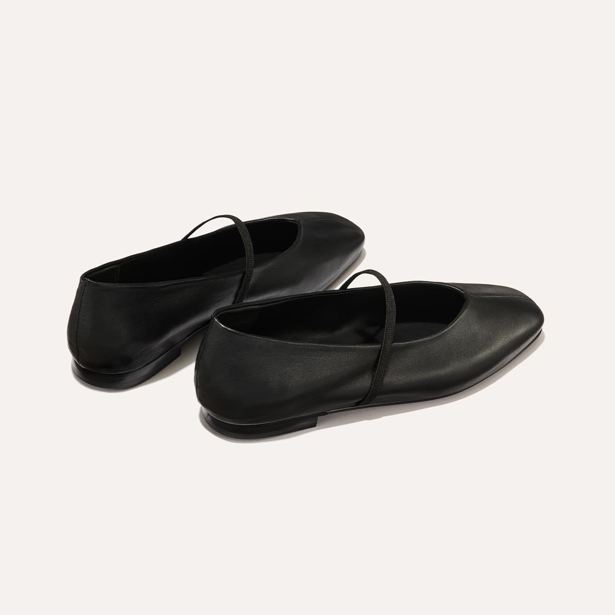 The Phoebe in smooth Black Nappa leather, a ballet flat with a squared off toe, high vamp and elastic Mary Jane strap.