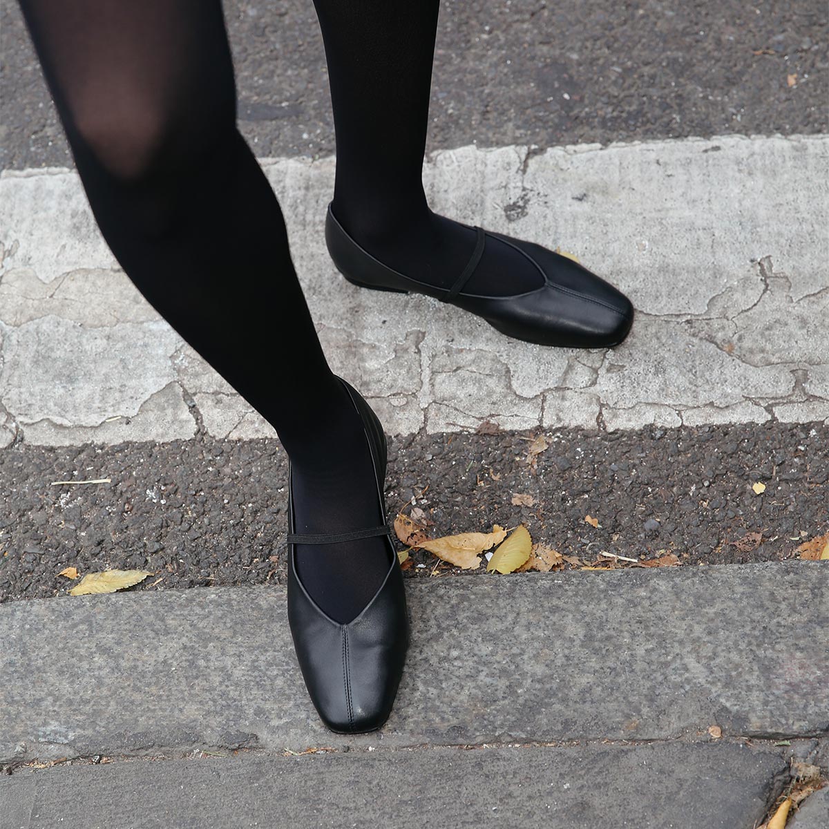 The Phoebe in smooth Black Nappa leather, a ballet flat with a squared off toe, high vamp and elastic Mary Jane strap.