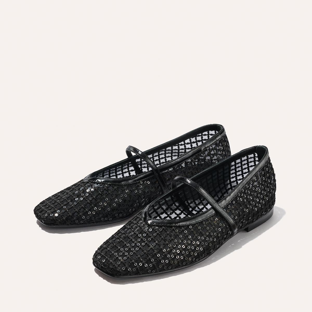 The Phoebe - Black Sequin Mesh by margaux-development are black deconstructed flats with mesh design, small sequins, a thin top strap, pointed toe, low heel, and sacchetto construction, handmade and shown on a light background.