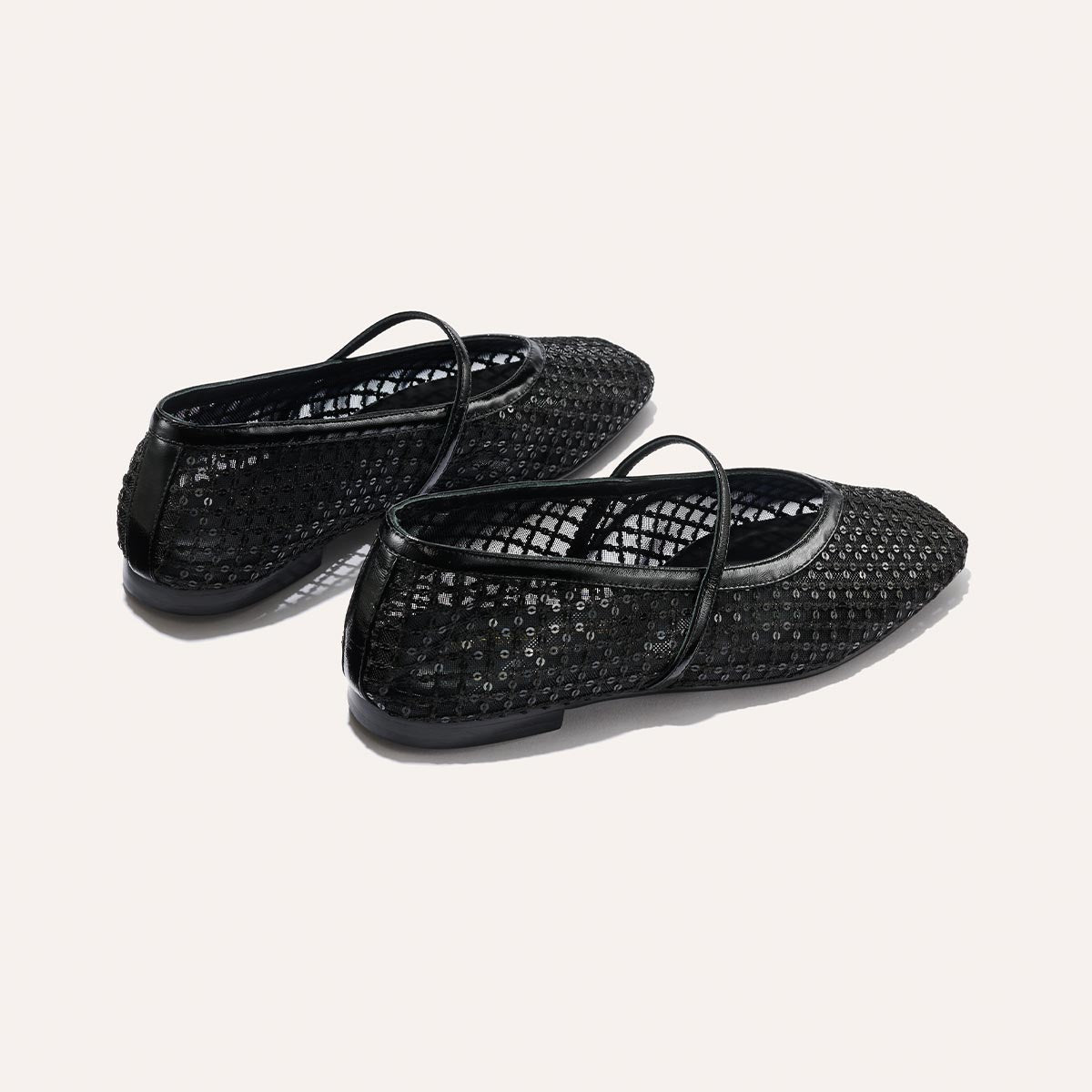 The Phoebe - Black Sequin Mesh by margaux-development: black mesh ballet flats with delicate sequins, thin black straps, and low black heels in a soft sacchetto construction, are displayed on a light background.
