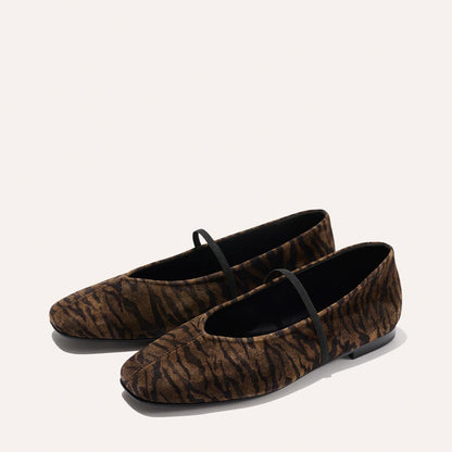 The Phoebe - Brown Zebra Suede by Margaux: flat ballet shoes featuring brown and black zebra stripes with thin black elastic straps across the top, shown on a light background.