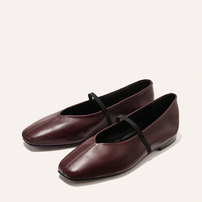 The Phoebe - Burgundy Nappa by margaux-development: burgundy leather ballet flats with squared toes and a thin black strap, crafted in sacchetto construction for the softest feel, displayed on a light background.