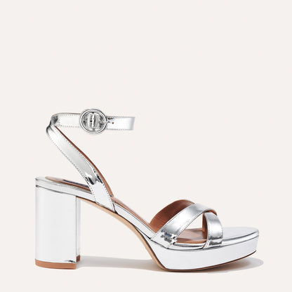 The Platform Sandal in shiny Silver Mirror, featuring a sleek ankle strap, perfectly placed straps across the toes and a comfortable 3.5-inch block heel.