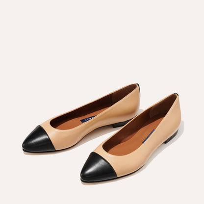 The Pointe in dune nappa, a classic and comfortable ballet flat featuring a refined pointed toe design and nappa leather cap-toe detail.