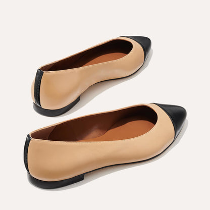 The Pointe in dune nappa, a classic and comfortable ballet flat featuring a refined pointed toe design and nappa leather cap-toe detail.