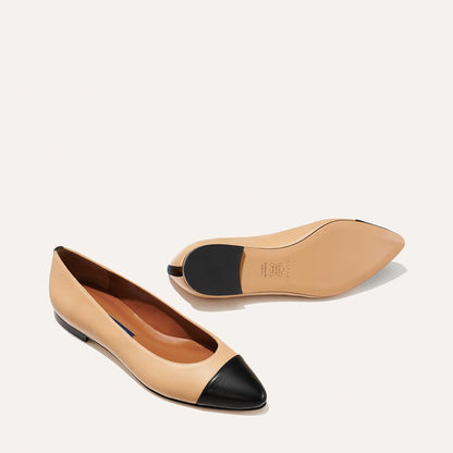 The Pointe in dune nappa, a classic and comfortable ballet flat featuring a refined pointed toe design and nappa leather cap-toe detail.