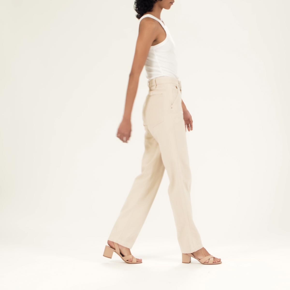 The City Sandal in Rose Nappa shown on model styled with a white tank top tucked into ivory straight leg denim.