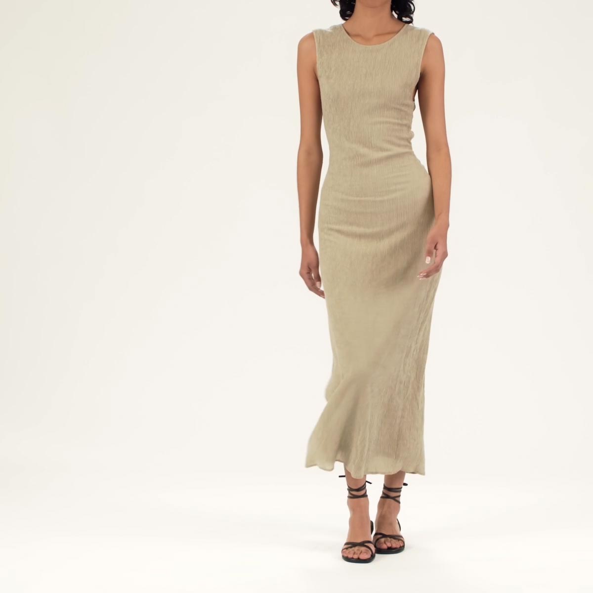The Wrap Sandal in Black Nappa shown on model styled with a beige sleeveless midi dress.