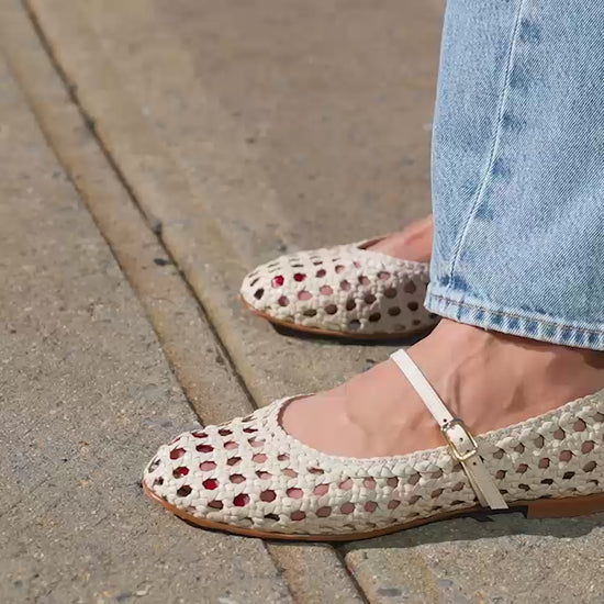 A ecru woven Mary Jane flat made from handwoven leather with a classic strap.