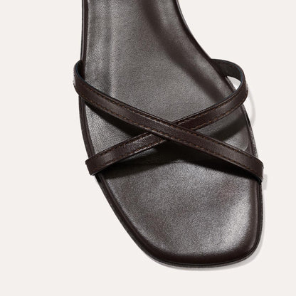 Close-up of Margauxs The Wrap Sandal in Espresso Nappa, featuring a square toe and two slender X-crossing straps—ideal for an iconic getaway look.