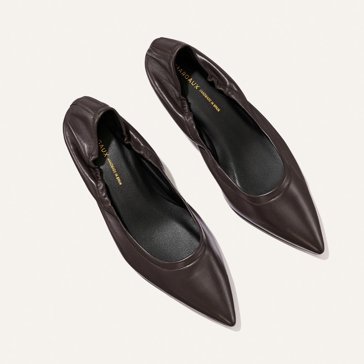 A pair of Margaux The Roma 40 - Espresso Nappa leather flats with pointed toes and elasticized heels, displayed on a light background.