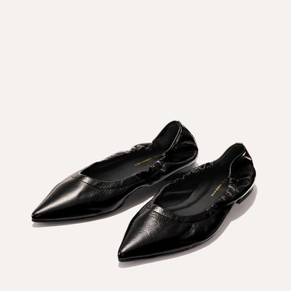 The Roma - Black Crinkle Patent by Margaux: black pointed-toe ballet flats with a ruched, elasticized opening, shown on a light background.