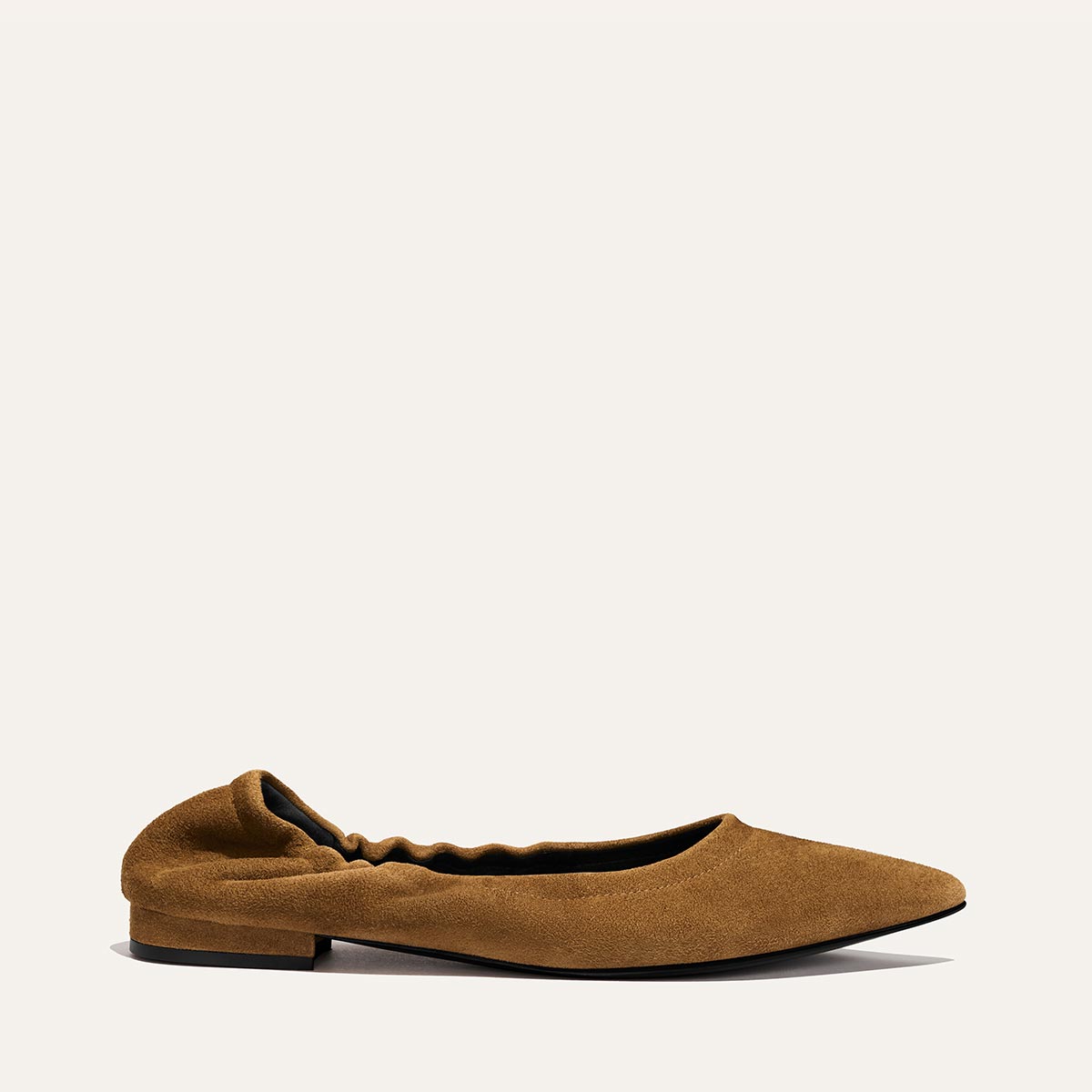 The Roma - Cedar Suede by Margaux is a classic ballet flat in brown suede, featuring a ruched elasticized back and a slightly pointed toe, shown against a plain, light background.