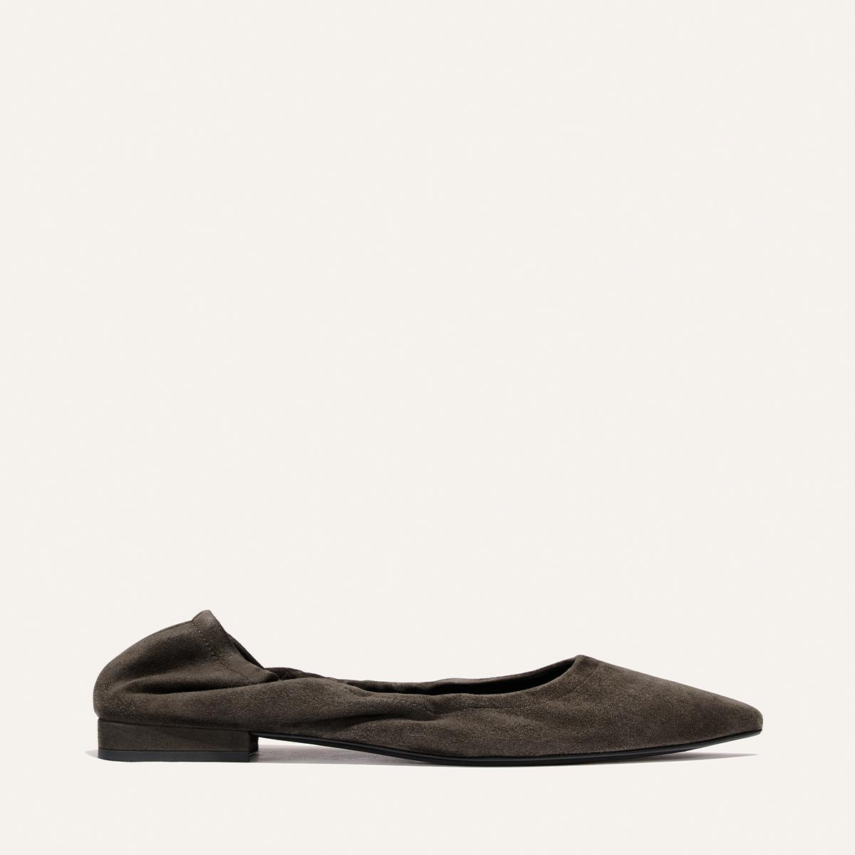 A single Margaux “The Roma - Graphite Suede” ballet flat, featuring dark graphite suede, a pointed toe, low heel, and slightly gathered detailing, displayed on a plain light background.