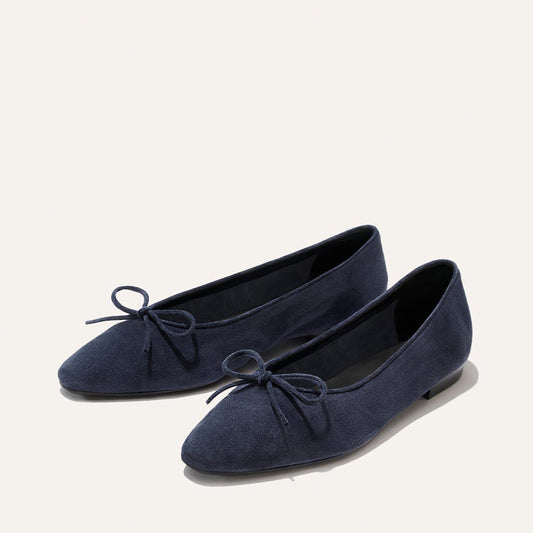 The Salamanca - Vintage Navy Suede ballet flats in navy blue suede, featuring a small bow on the toe, unlined construction, and a pointed-toe silhouette.