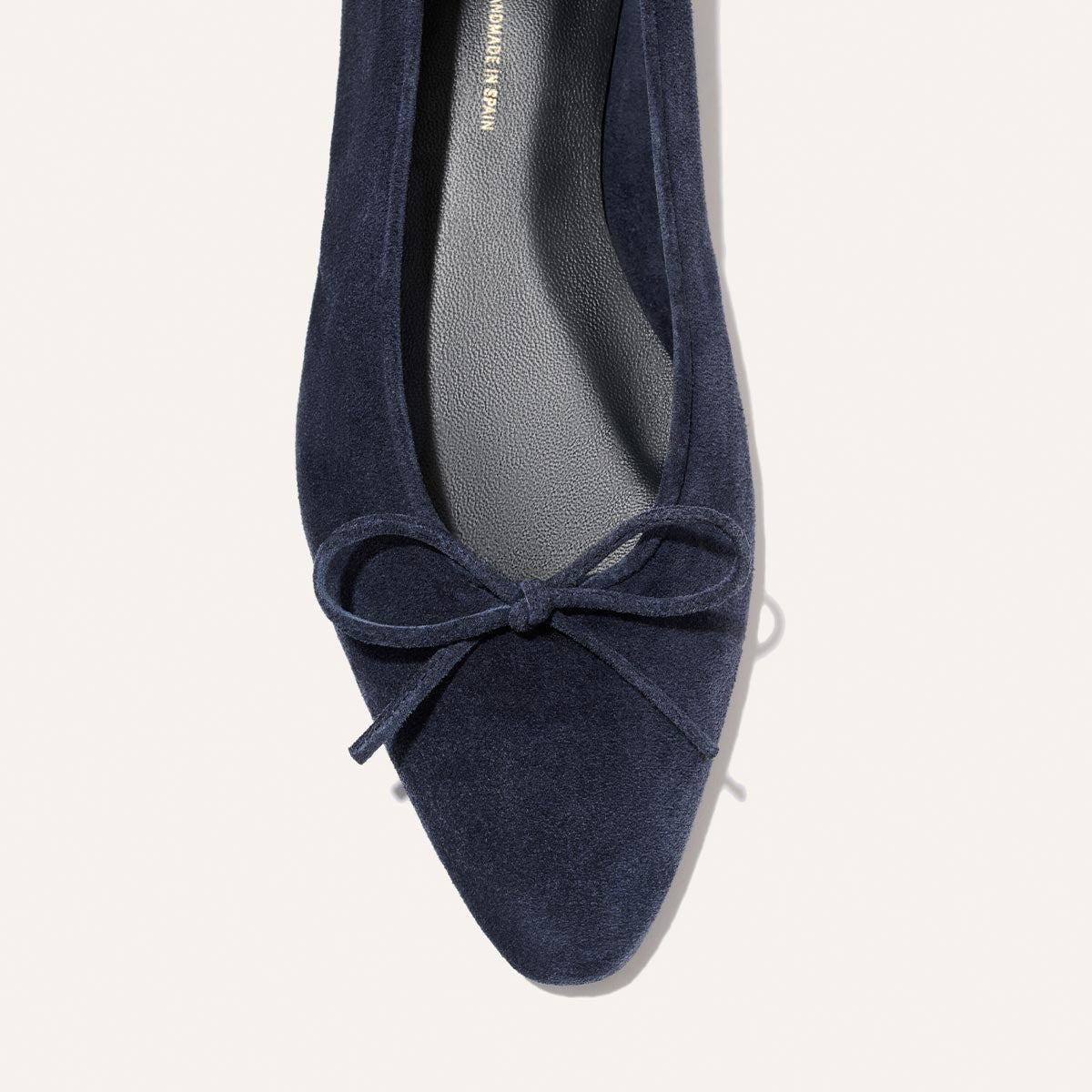 The Salamanca - Vintage Navy Suede ballet flat with an unlined construction and a small bow on the rounded toe.