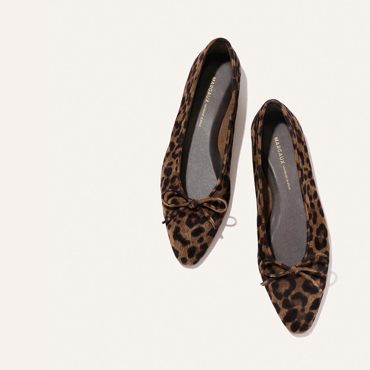 The Salamanca - Brown Leopard Suede by Margaux: pointed-toe ballet flats in buttery soft suede, featuring a brown leopard print and delicate front bows.