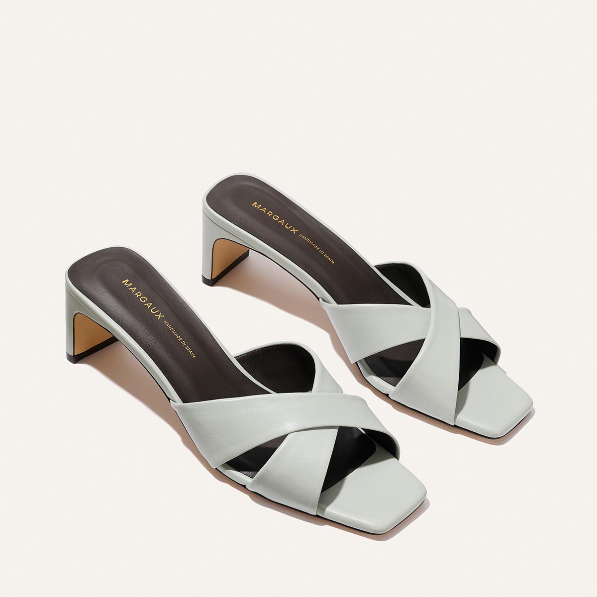The Selene 50 - Sky Nappa light blue leather slip-on heeled sandals with a low block heel and an open square toe.