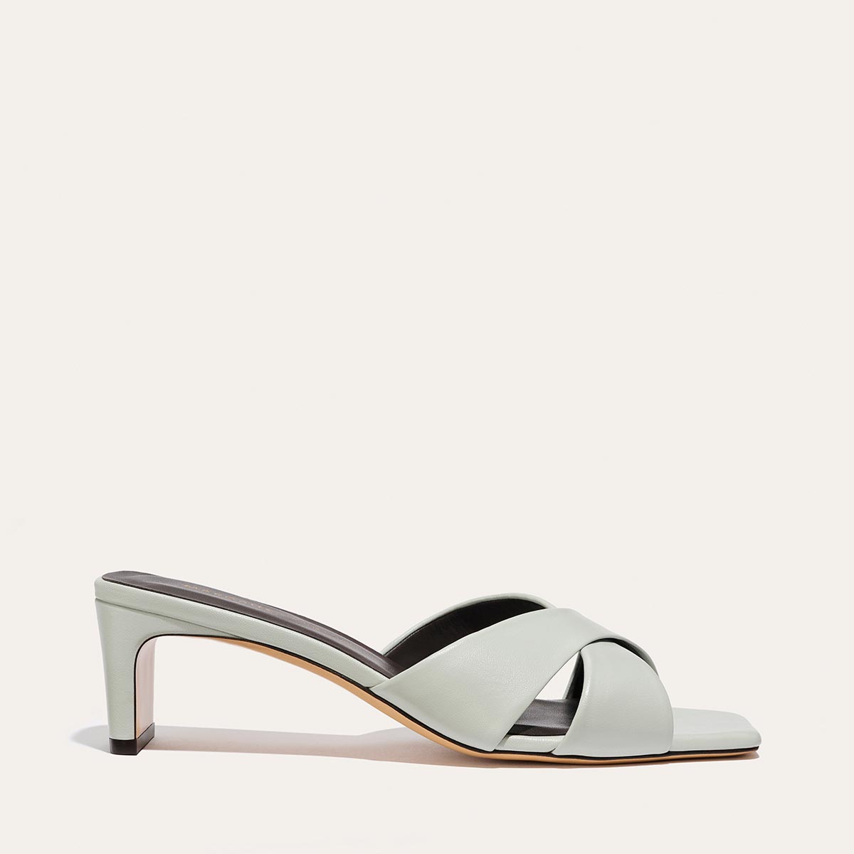 The Selene 50 - Sky Nappa light blue slip-on heeled sandal featuring a square toe, a low block heel, and a padded insole.