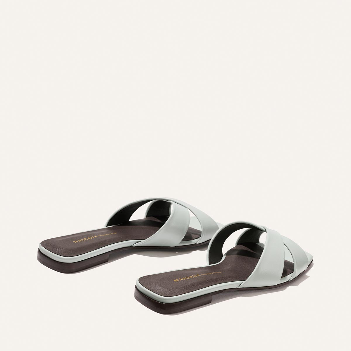 Pair of light blue sandals on a white background