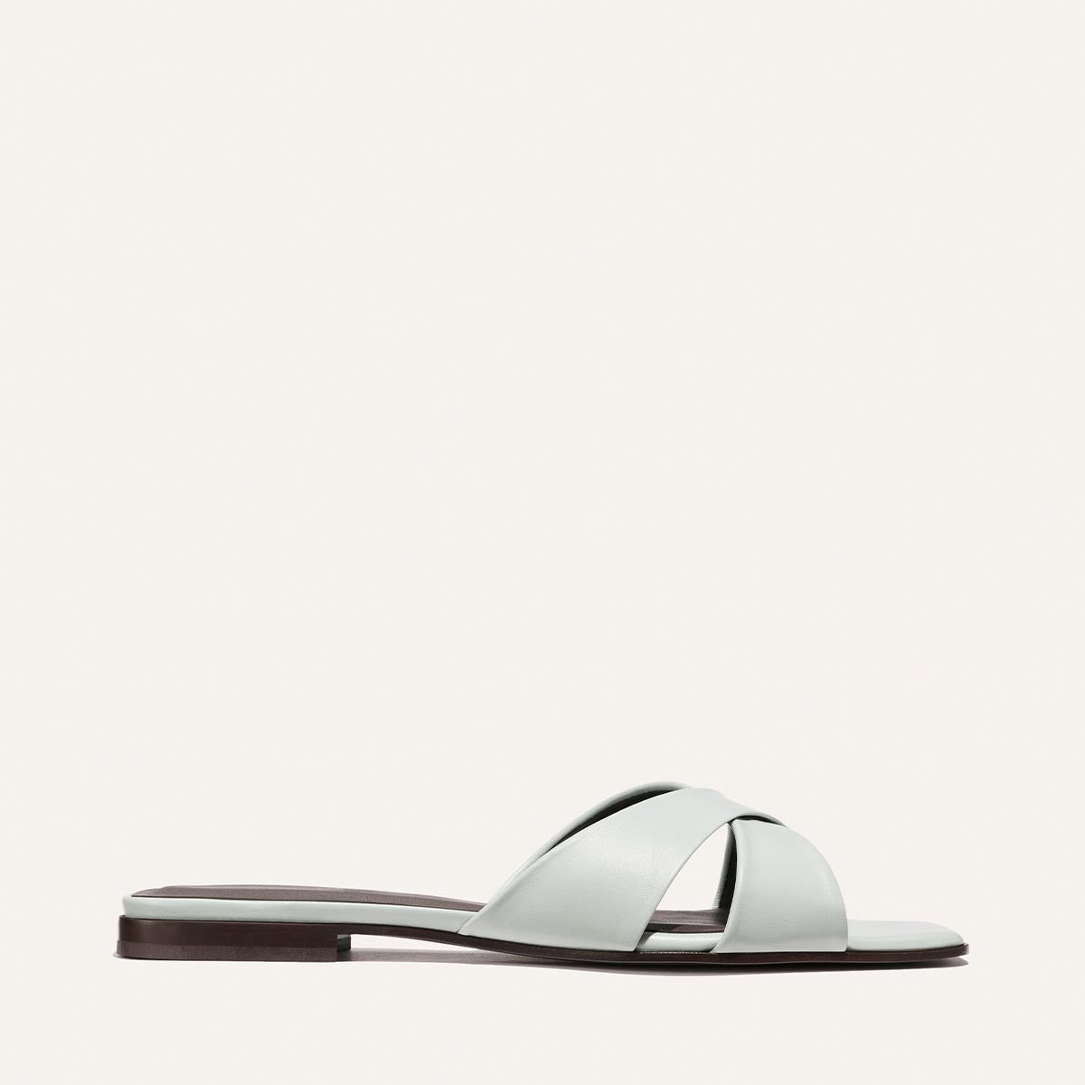 Light blue sandal with a brown sole on a white background