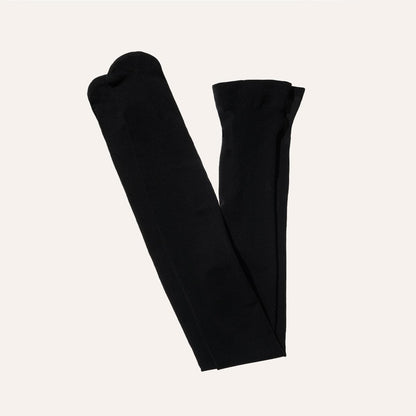 Margaux Semi-Sheer Tights in Black, neatly folded with toes and waistband visible, displayed against a plain off-white background.