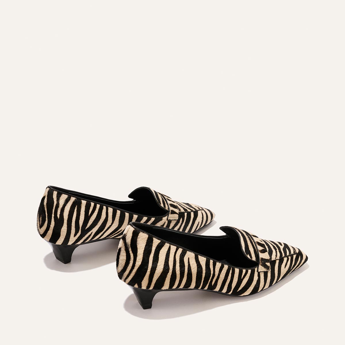 Two tan and black zebra-striped haircalf kitten heel loafers, The Sigrid - Tan Zebra Haircalf.