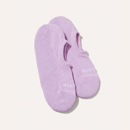 The Sneaker Sock - Wisteria by Margaux: a pair of lavender no-show socks with white toe text and non-slip grips, shown on a plain white background.