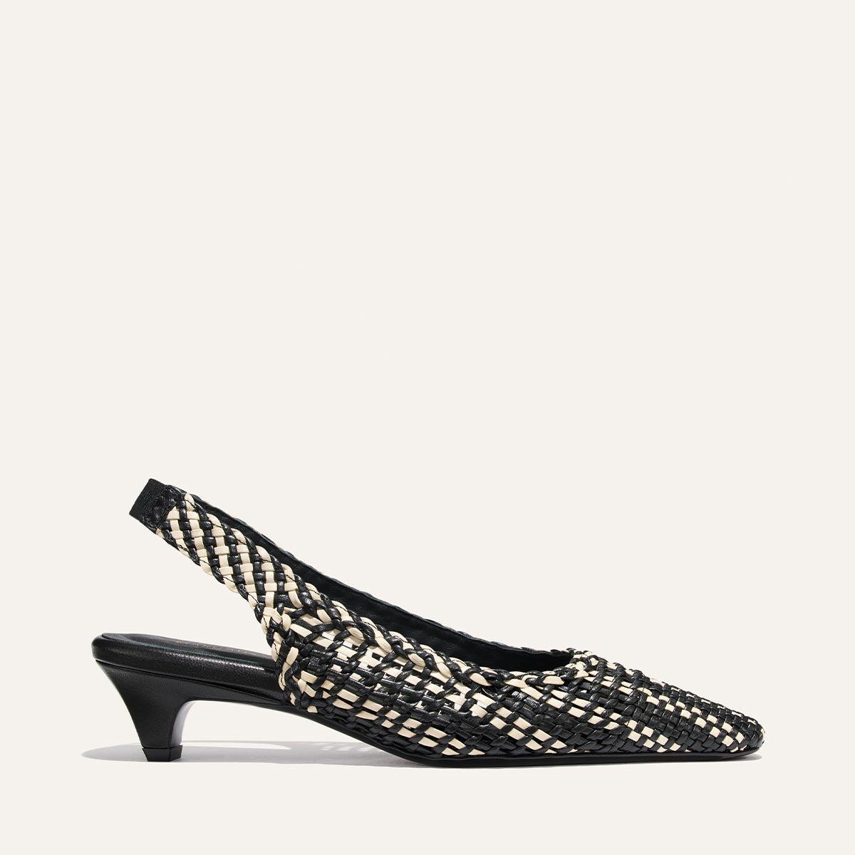 Black and white woven slingback shoe on a white background