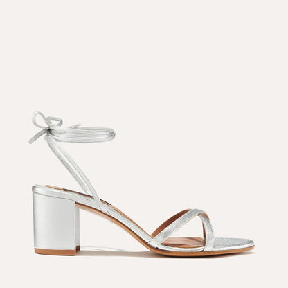 The Soho Sandal in Silver Nappa, featuring thin, flattering straps with a delicate ankle wrap, and a comfortable 2.5-inch block heel.