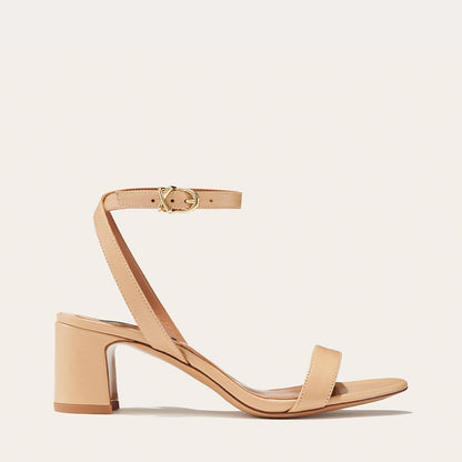 The Stella Sandal in Dune Nappa, featuring a sleek strap across the toes and a comfortable 2.5-inch breasted heel.