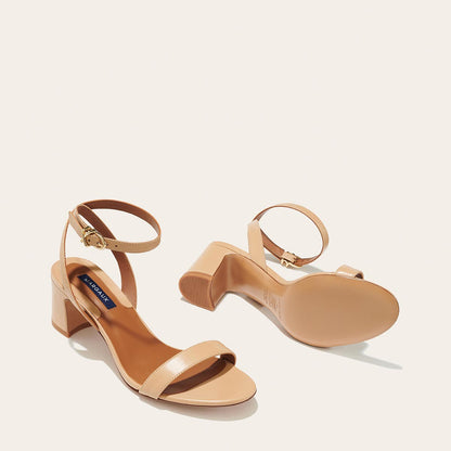 The Stella Sandal in Dune Nappa, featuring a sleek strap across the toes and a comfortable 2.5-inch breasted heel.