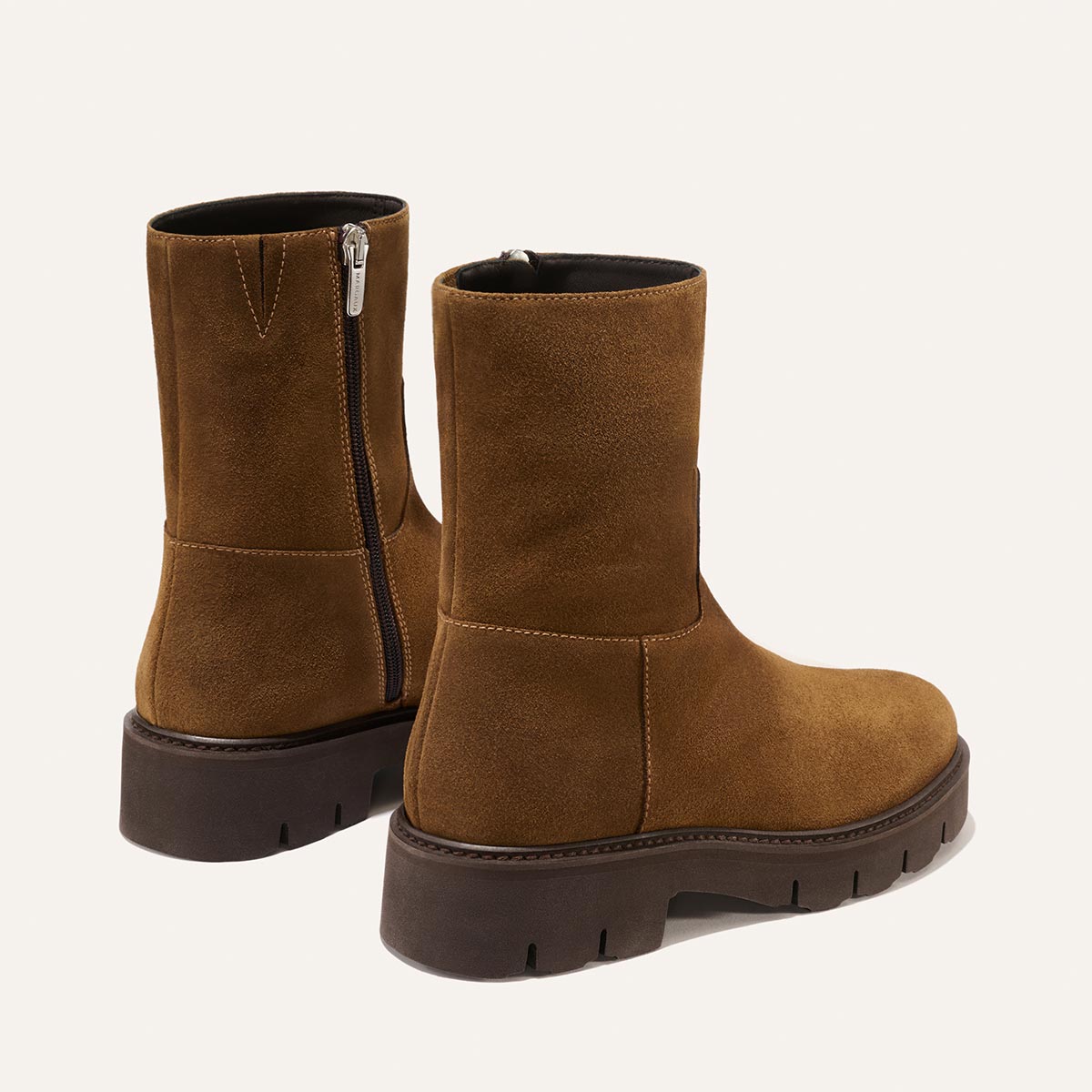 The Wells Boot - Cedar Suede by Margaux: a pair of brown suede mid-calf boots featuring chunky dark soles and side zippers, displayed on a light background.