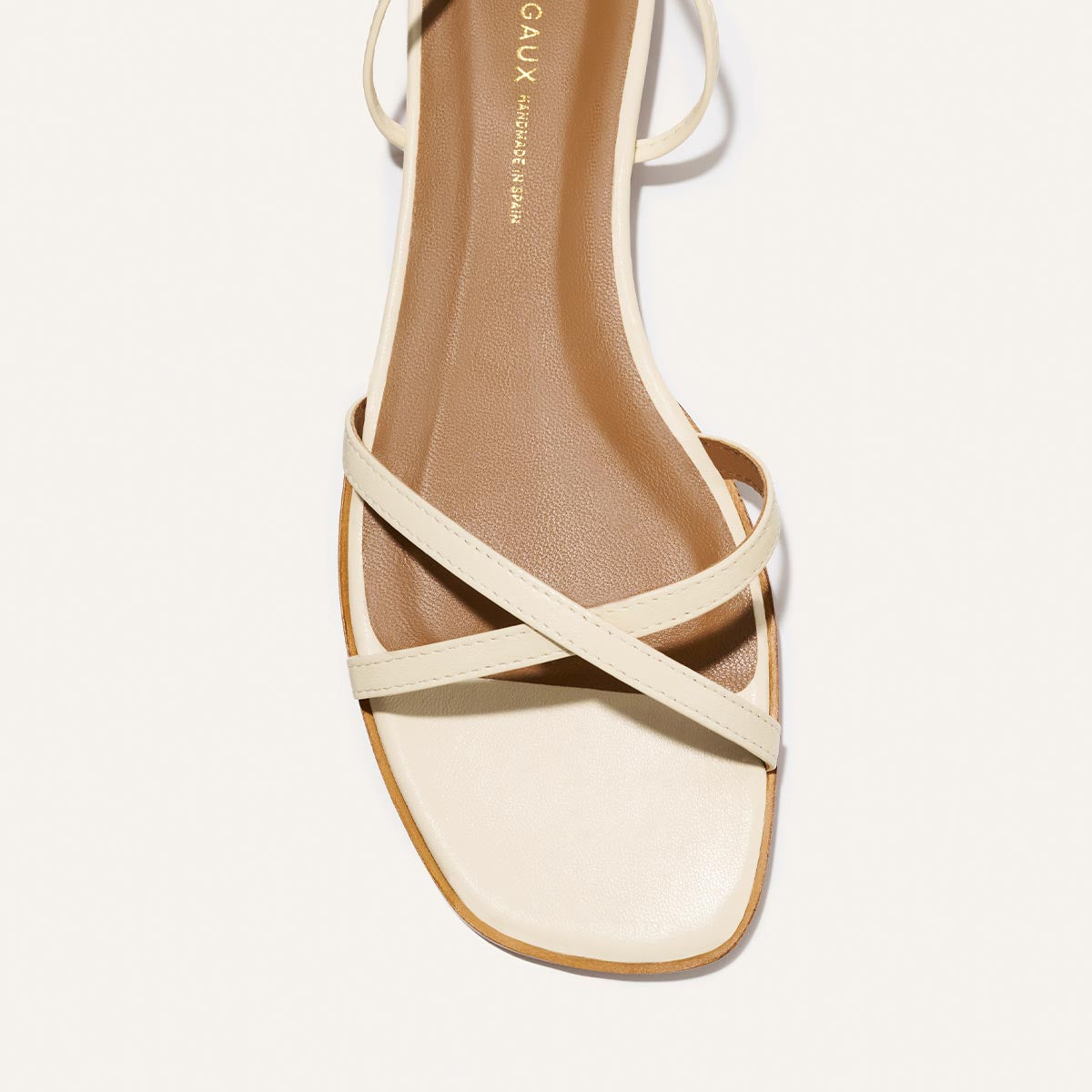 Strappy sandal with beige straps on a white background