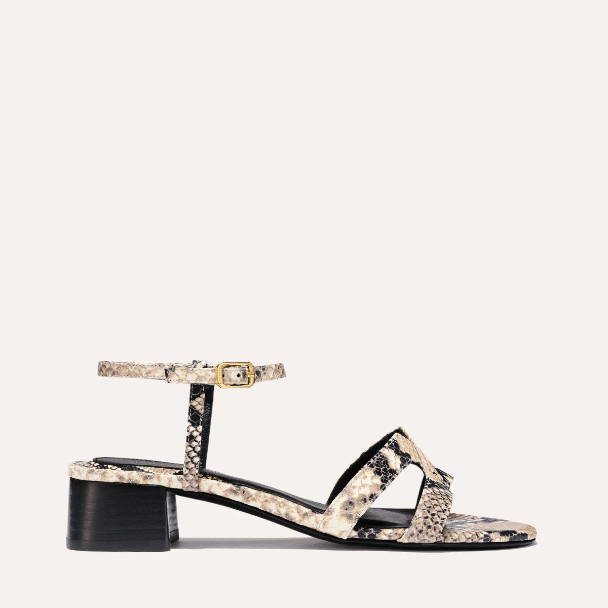Low heeled sandals shown in natural embossed python