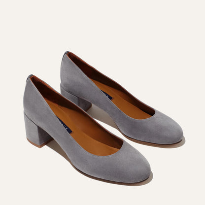 The Heel - Steel Suede by Margaux: women's gray suede block-heeled shoes with rounded toes and tan insoles, blending comfort and refined style, displayed on a light background.