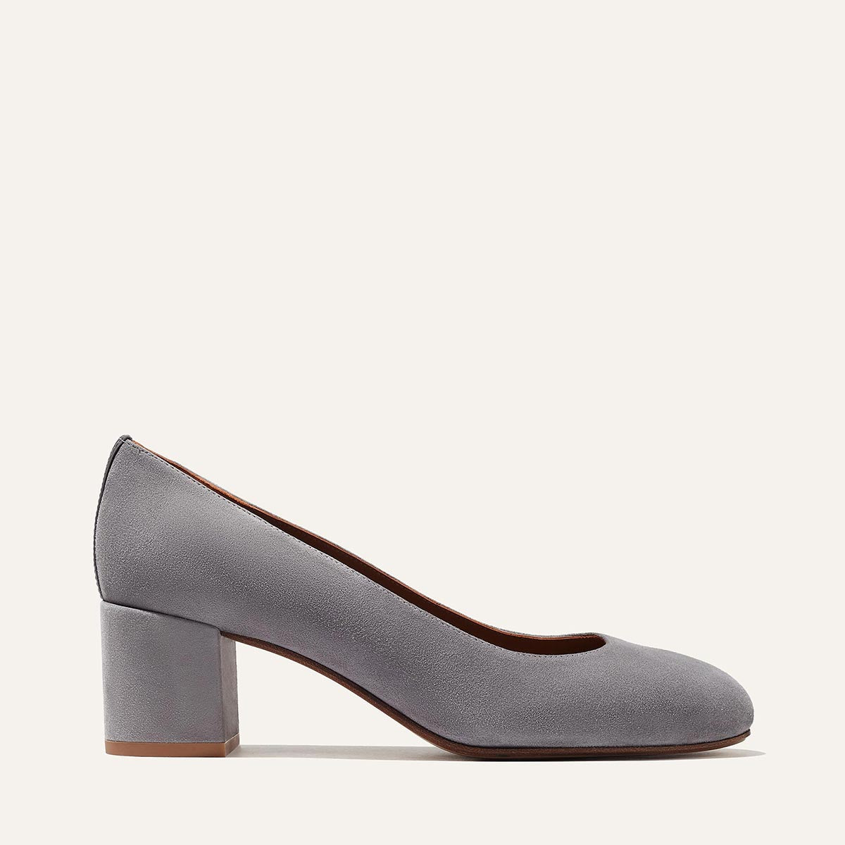 The Heel - Steel Suede by Margaux: a gray suede women's pump with a rounded toe and elegant block heel, shown in side profile against a plain light background.