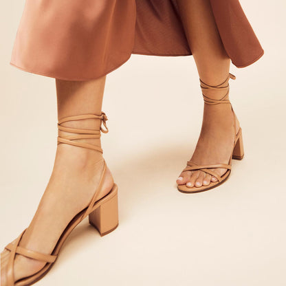 The Soho Sandal in Desert Nappa, featuring thin, flattering straps with a delicate ankle wrap, and a comfortable 2.5-inch block heel.
