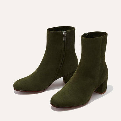 The Boot - Olive Suede by Margaux features elegant almond toes, side zippers, and block heels in rich olive green suede, shown on a light background.