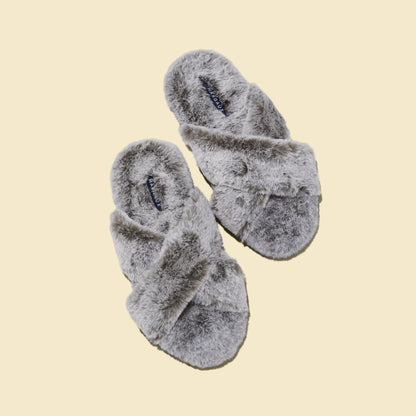The Cozy Slipper - Grey by Margaux features a fluffy, x-strap design with open toes and is shown on a beige background.