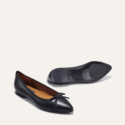The Pointe in Black Nappa, a classic and comfortable ballet flat featuring a refined pointed toe design and decorative bow. 